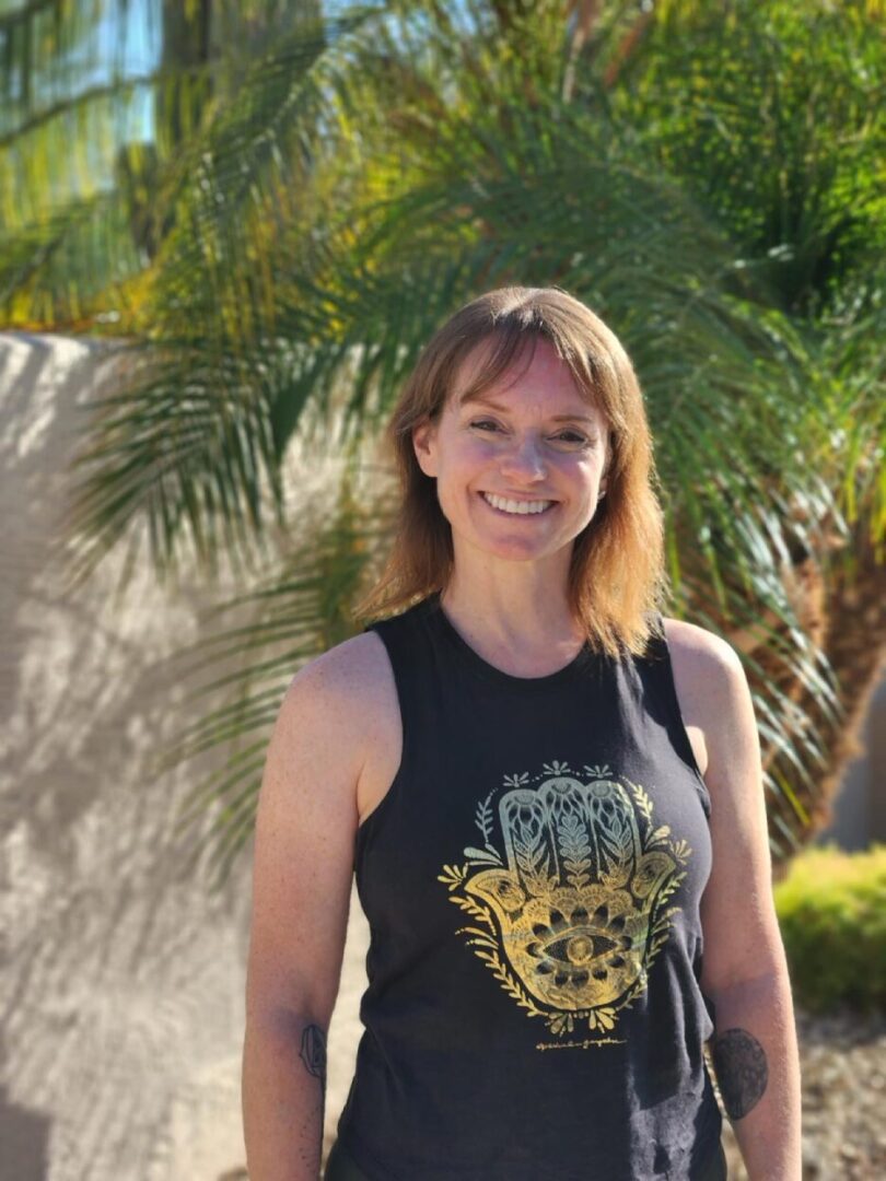 A woman standing in front of some trees