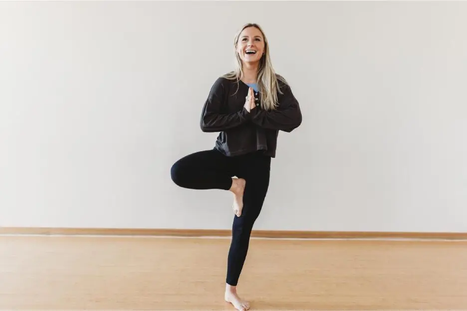 A woman is doing yoga in the middle of her legs.