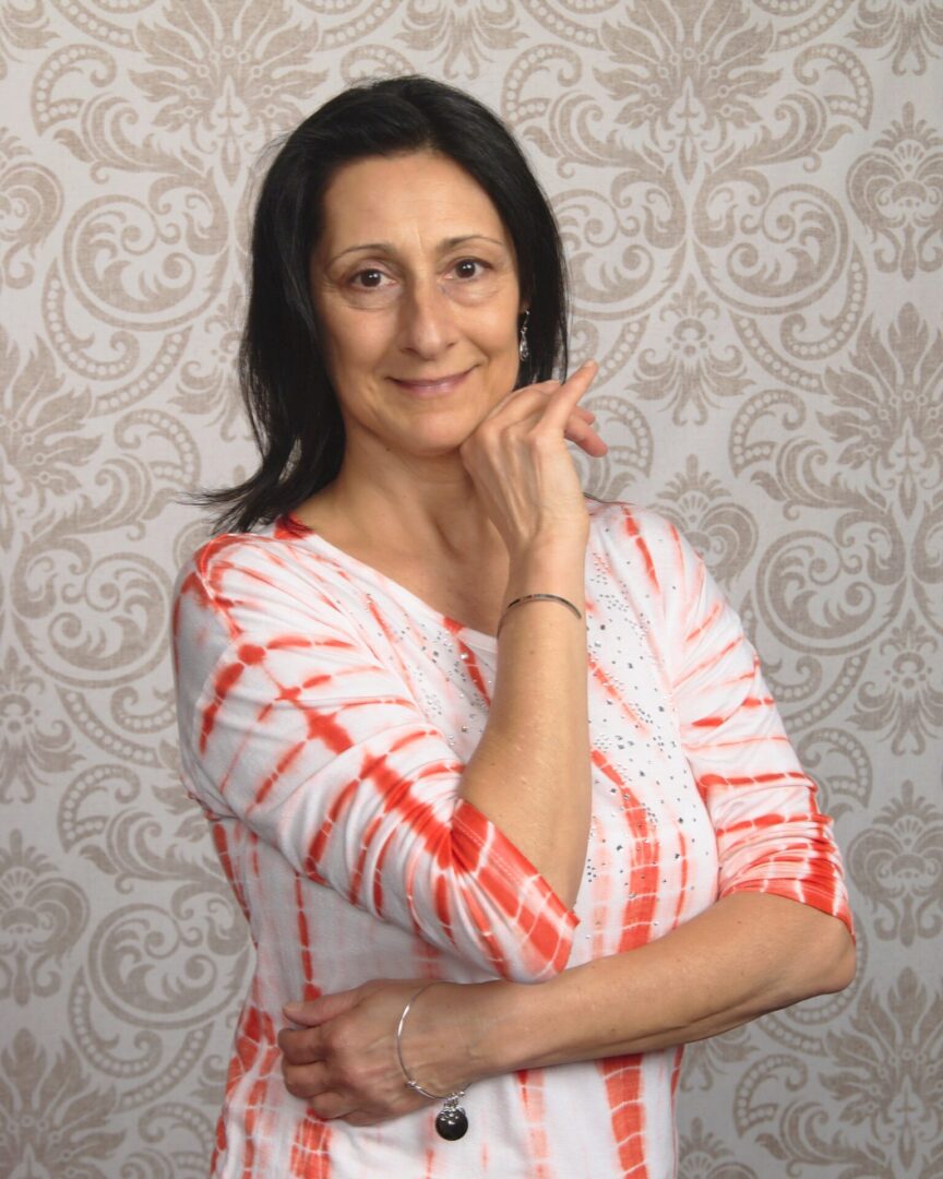 A woman in a white and red dress posing for the camera.