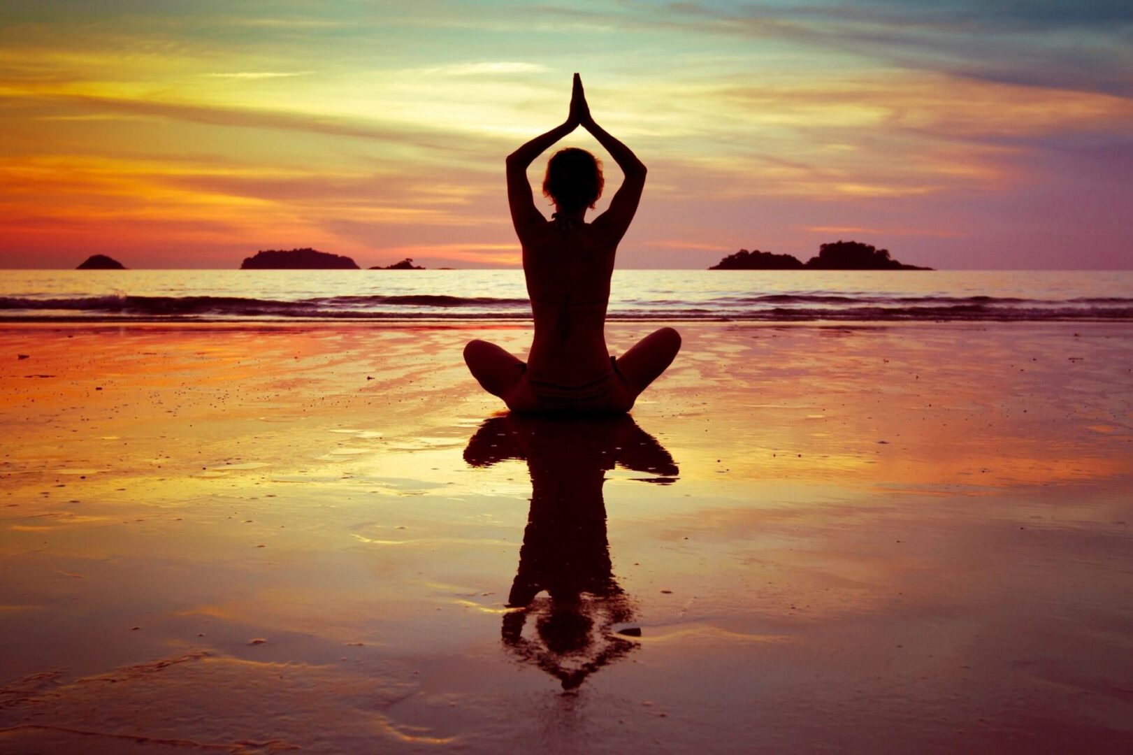 A person sitting in the water doing yoga.