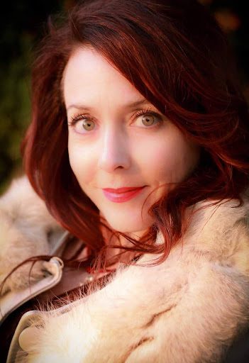 A woman with red hair and a fur coat.