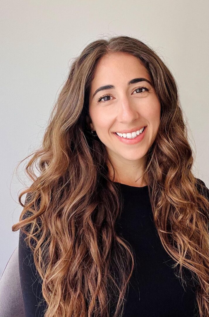 Smiling woman with long brown hair.