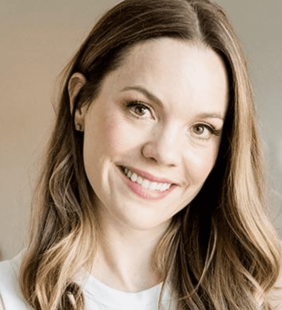 Smiling woman with long brown hair.