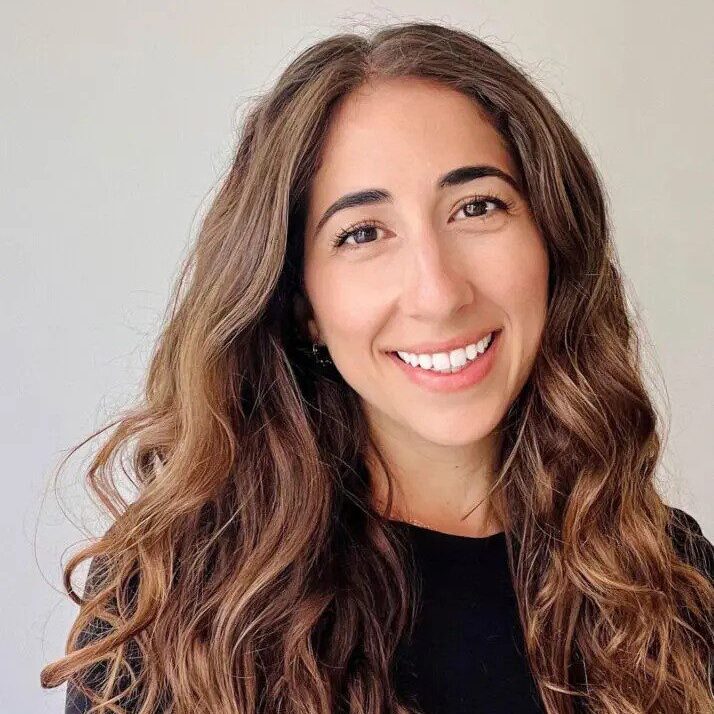 Portrait of a smiling woman with long hair.