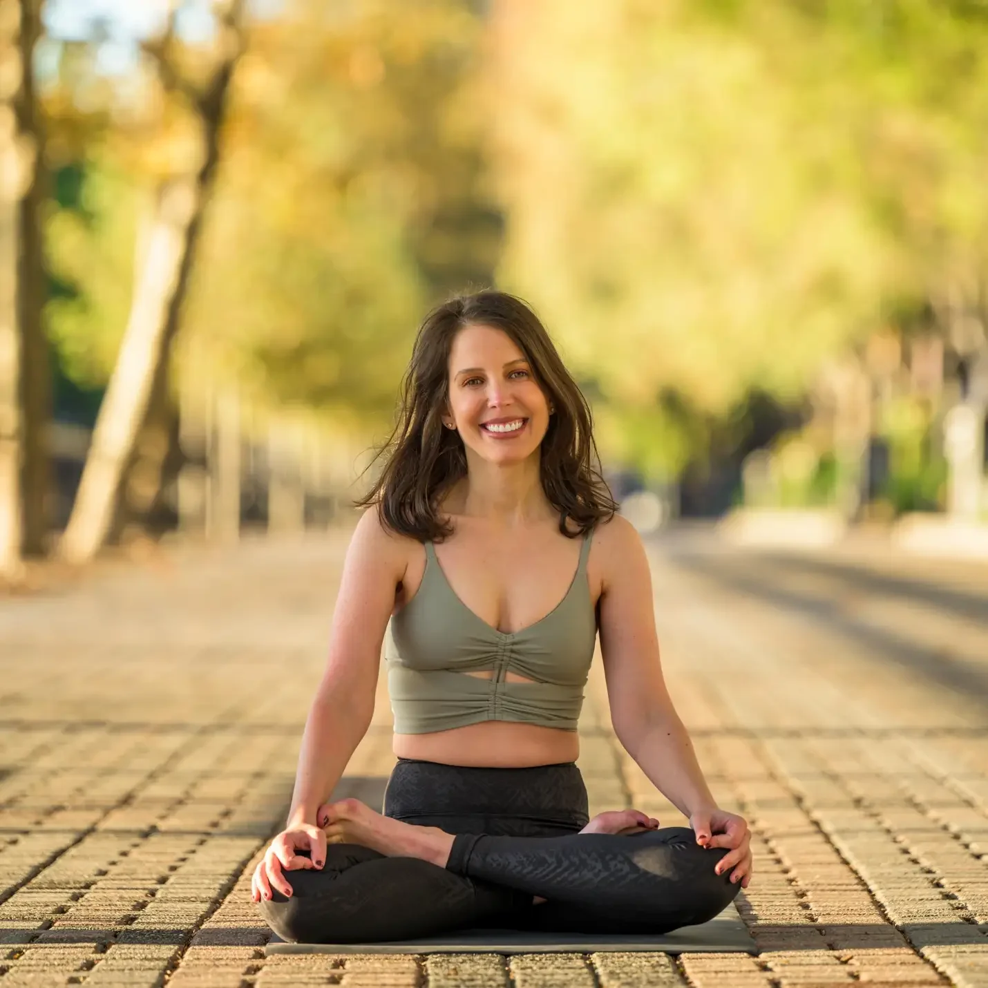 Smiling woman meditating in yoga pose.