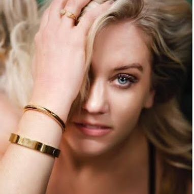 A woman with long blonde hair wearing a gold bracelet.