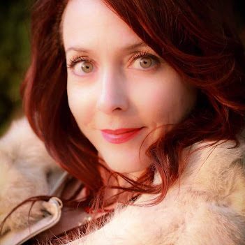 A woman with red hair and a fur coat.