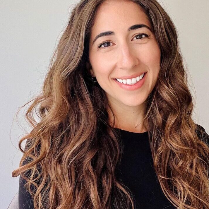 Smiling woman with long brown hair.