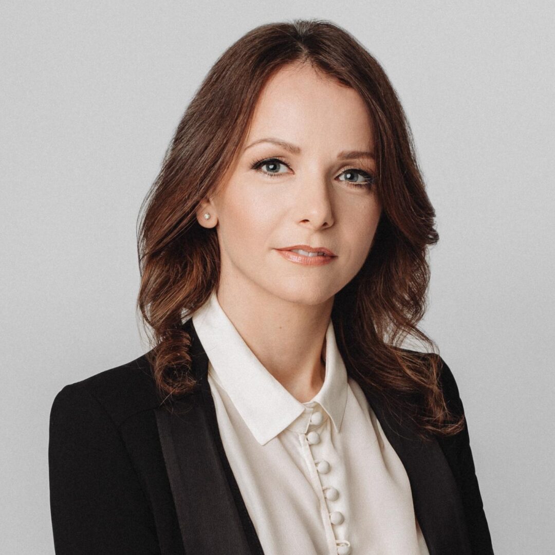 Woman in black blazer and white shirt.